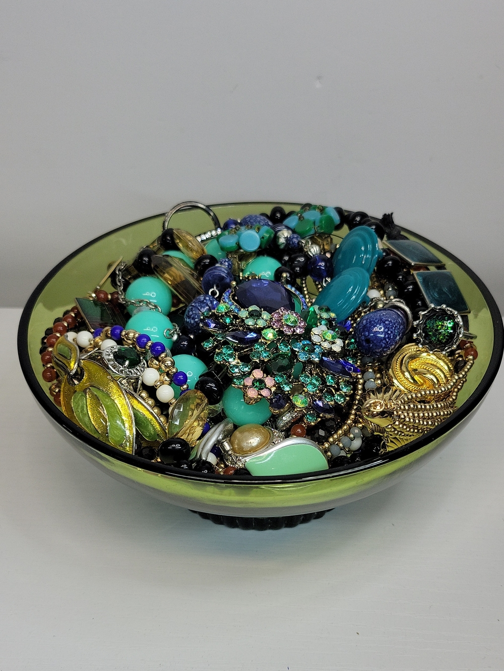 Green Glass Bowl Filled With Jewelry